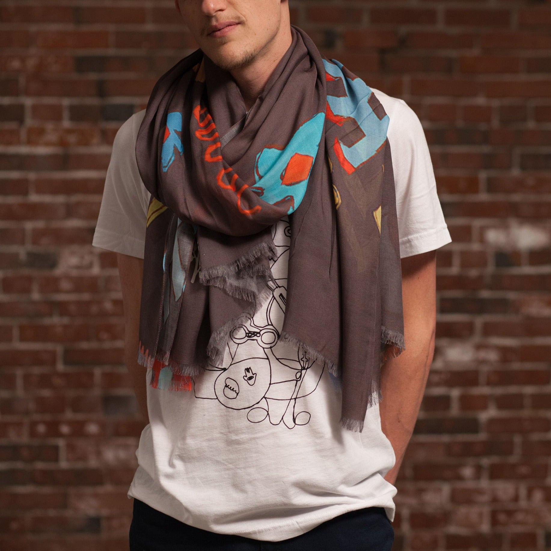 Djenné Wahala Mud Large Art Cashmere Blend Scarf loose wrap on male model in white t-shirt